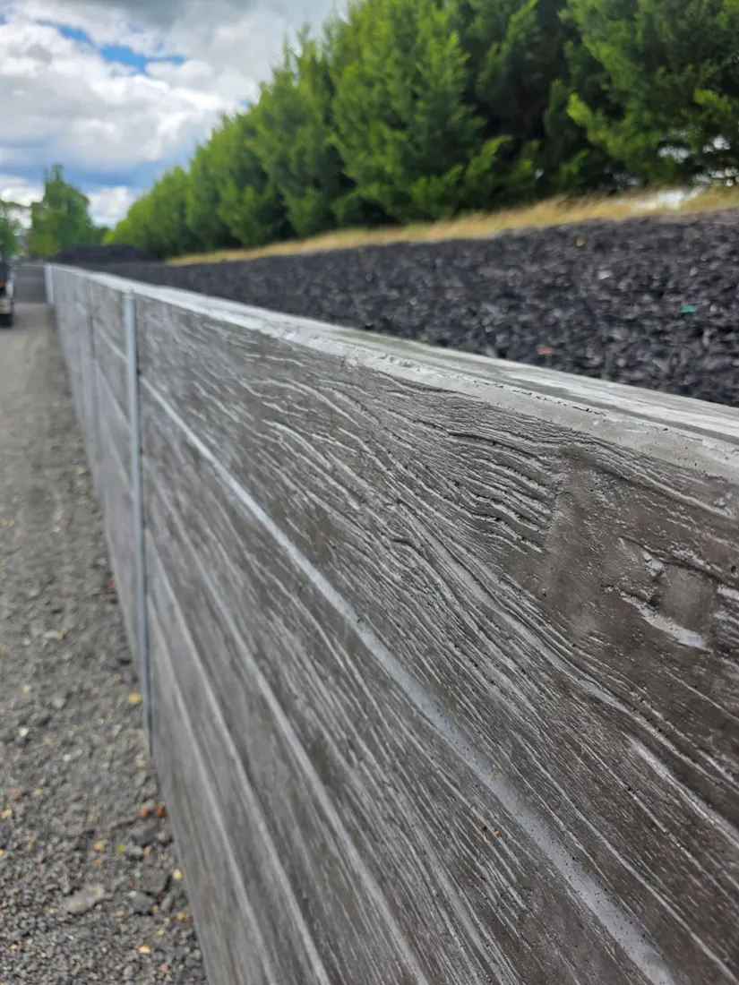 Close-up of woodgrain sleeper retaining wall finish